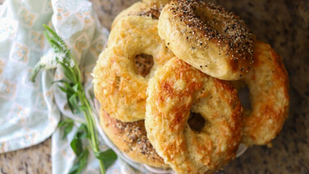 Plate of homemade einkorn sourdough bagels with cheese and seasoning
