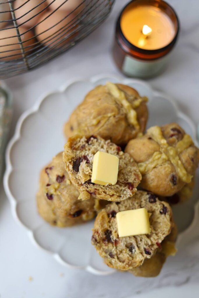 Plate of sourdough einkorn hot cross buns with dried fruit