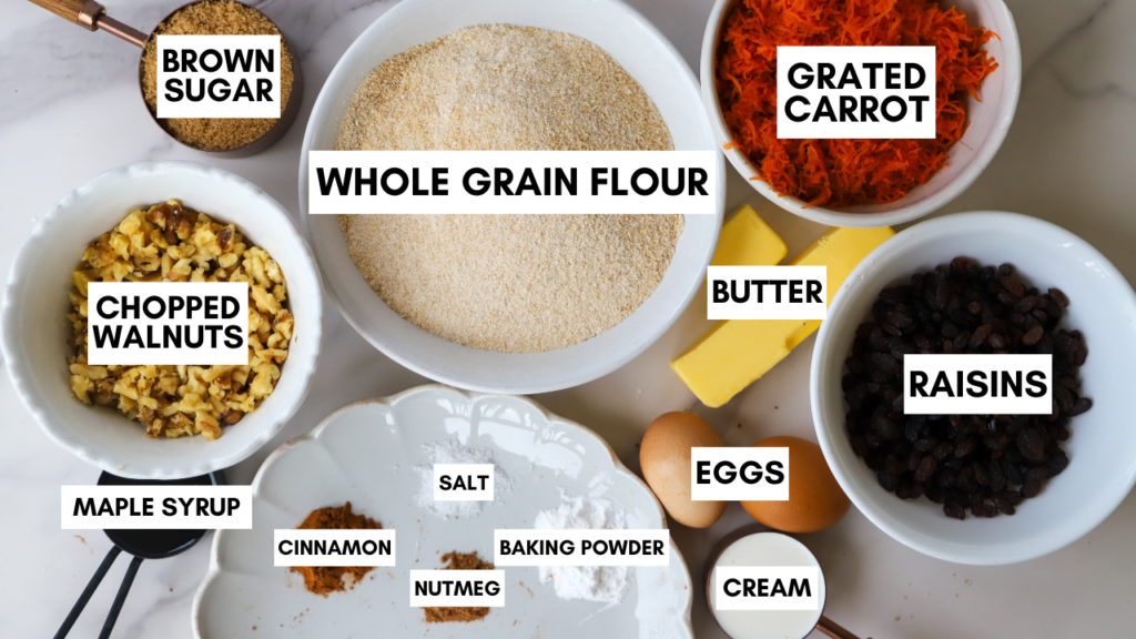 Ingredients for carrot cake loaf including whole grain flour, grated carrots, walnuts, eggs, and raisins.