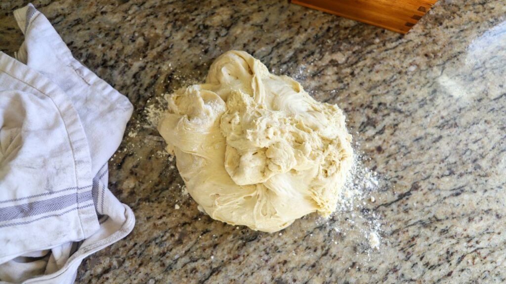 Ball of einkorn sourdough bagel dough resting on countertop