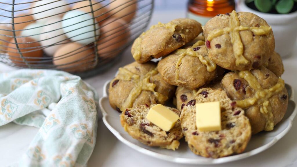 Plate of sourdough einkorn hot cross buns with butter