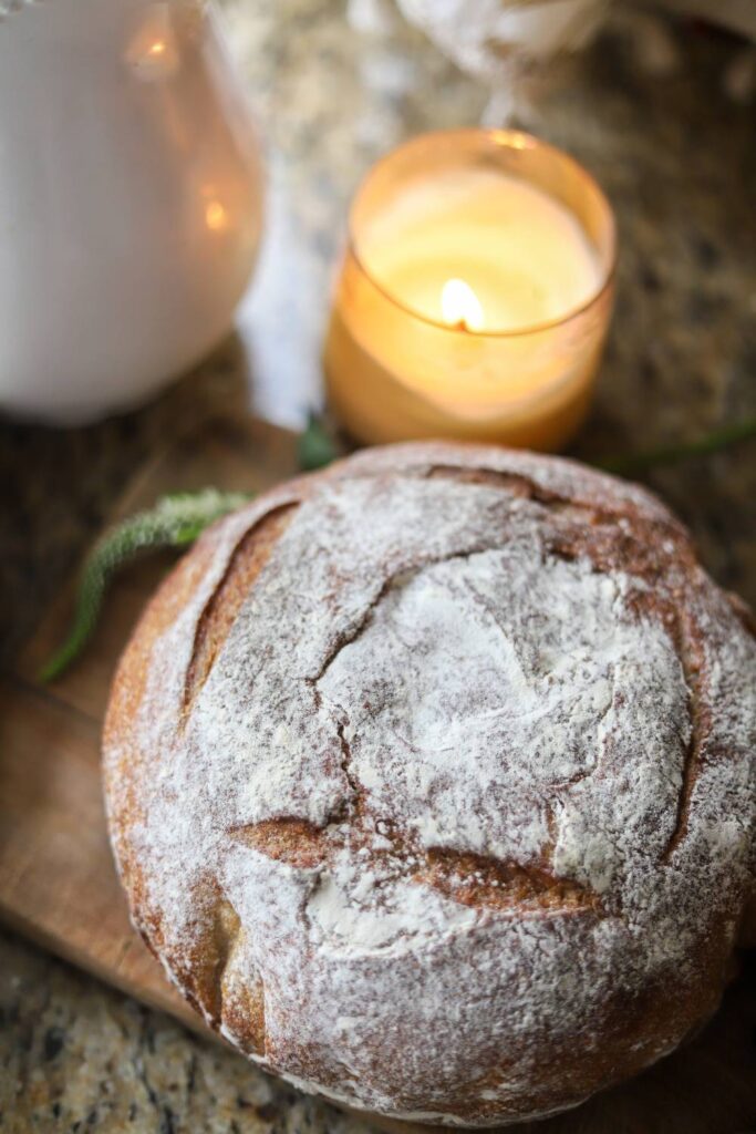 Close-up of whole grain sourdough buttermilk bread loaf with flour-dusted crust