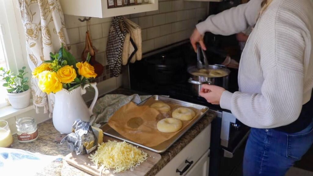 Boiling homemade einkorn sourdough bagels on stovetop