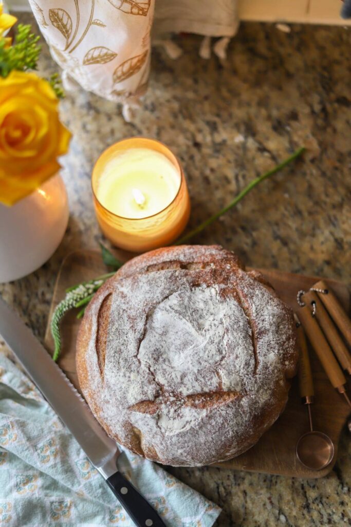 Rustic whole grain sourdough buttermilk bread loaf on a cutting board