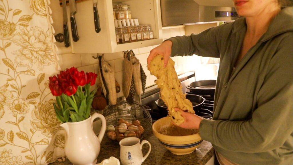 Stretching sourdough einkorn hot cross bun dough in a mixing bowl