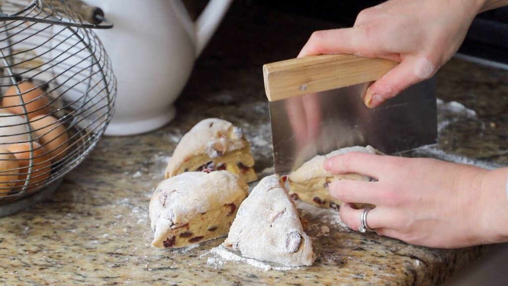 Cutting sourdough einkorn hot cross bun dough into portions