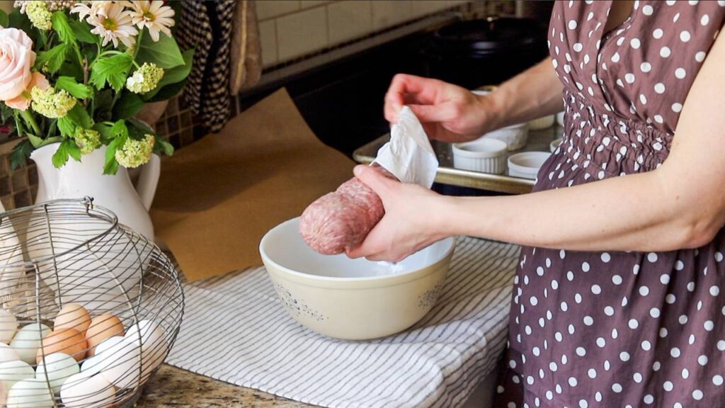 Adding ground beef to bowl for easy meatloaf recipe