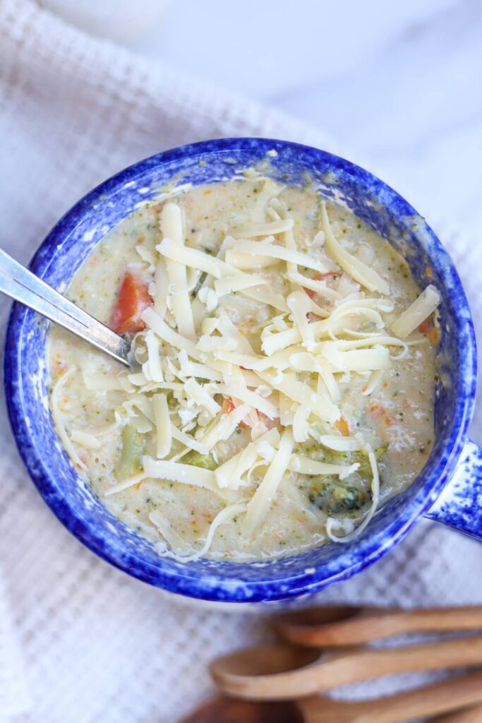 Top view of creamy broccoli cheddar soup with cheese
