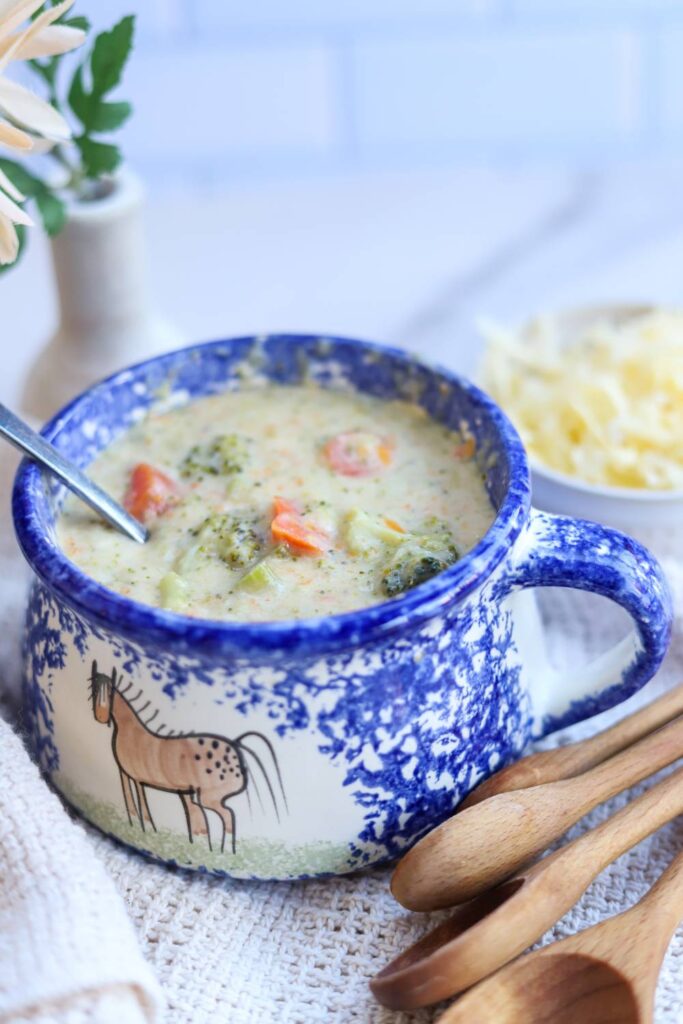 Bowl of homemade broccoli cheddar soup with vegetables