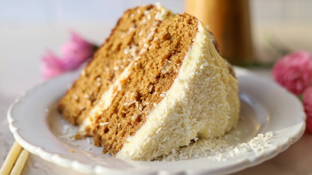 Close up slice of einkorn cake with cream cheese frosting
