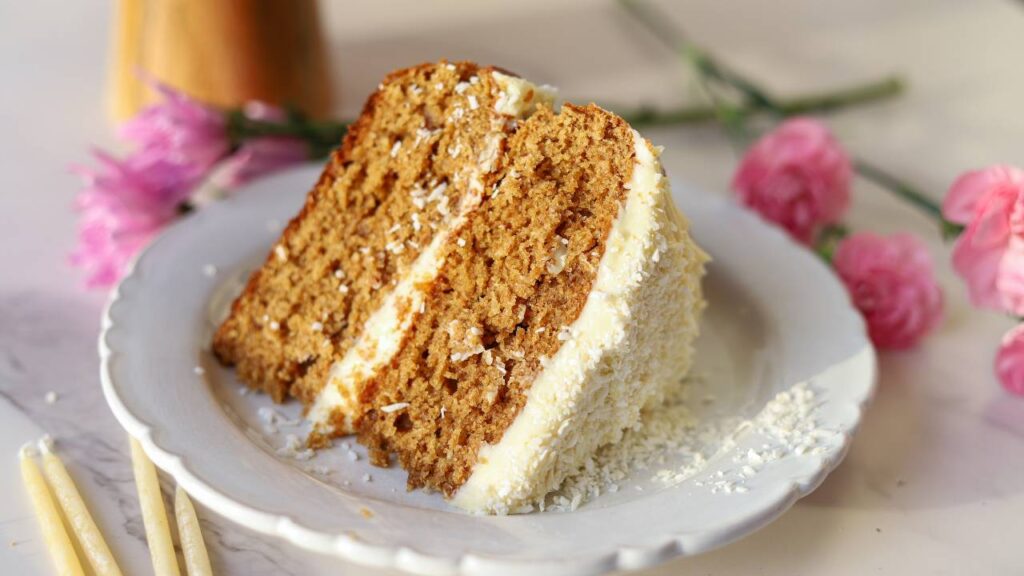 Slice of einkorn coconut almond cake on plate