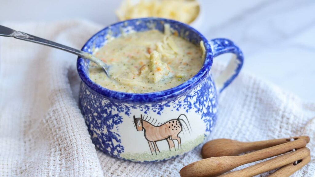Bowl of healthy broccoli cheddar soup with shredded cheese