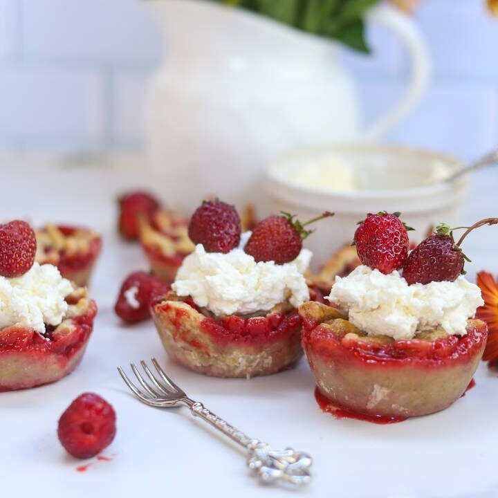 Fresh strawberry mini pies served with whipped cream