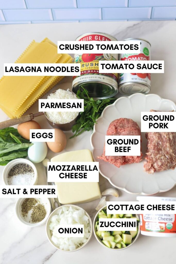 Ingredients for homemade cottage cheese lasagna with ground beef, pork, zucchini, cottage cheese, mozzarella, and lasagna noodles.