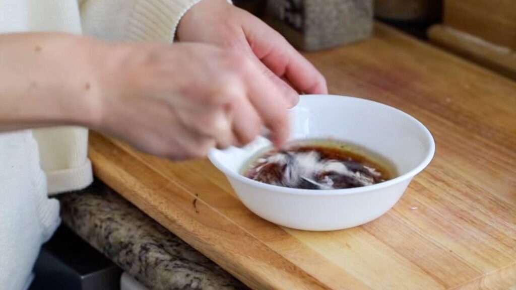 Mixing the maple BBQ glaze in a small bowl.