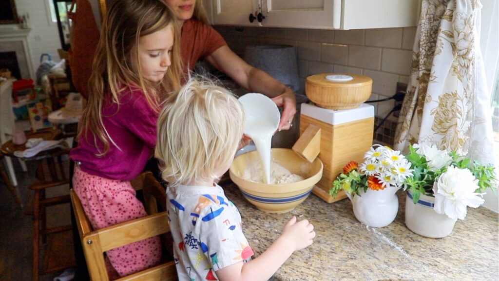Making whole grain einkorn strawberry pancakes with kids in the kitchen.