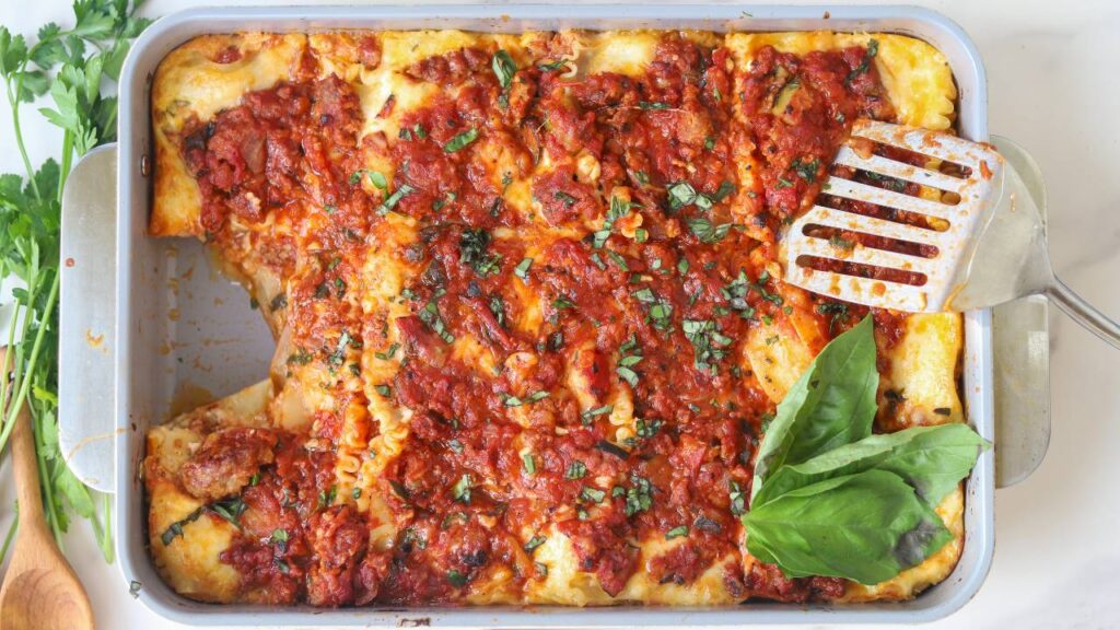 Homemade cottage cheese lasagna with one slice removed from the baking dish.