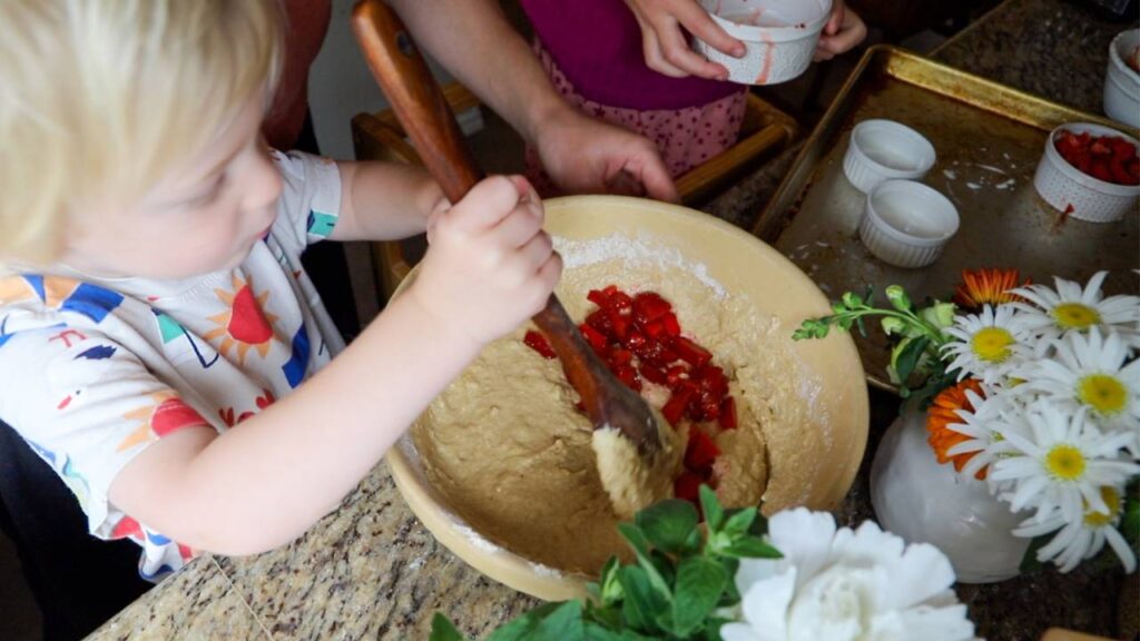 Mixing fresh strawberries into whole grain einkorn pancake batter.
