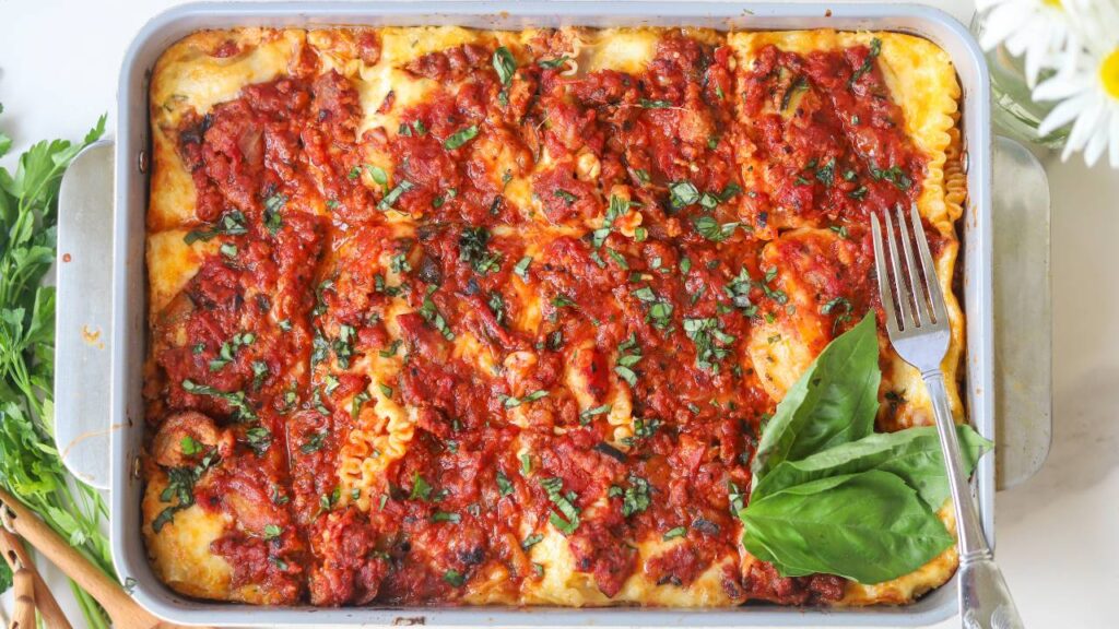 Homemade cottage cheese lasagna baked until bubbly and topped with fresh basil.