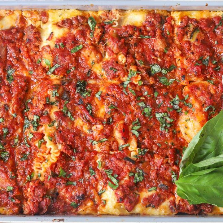 Homemade cottage cheese lasagna baked until bubbly and topped with fresh basil.