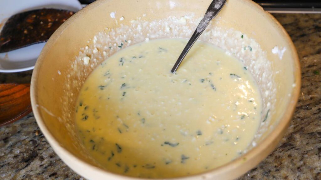 Cottage cheese mixture with eggs, Parmesan cheese, and fresh herbs for lasagna.