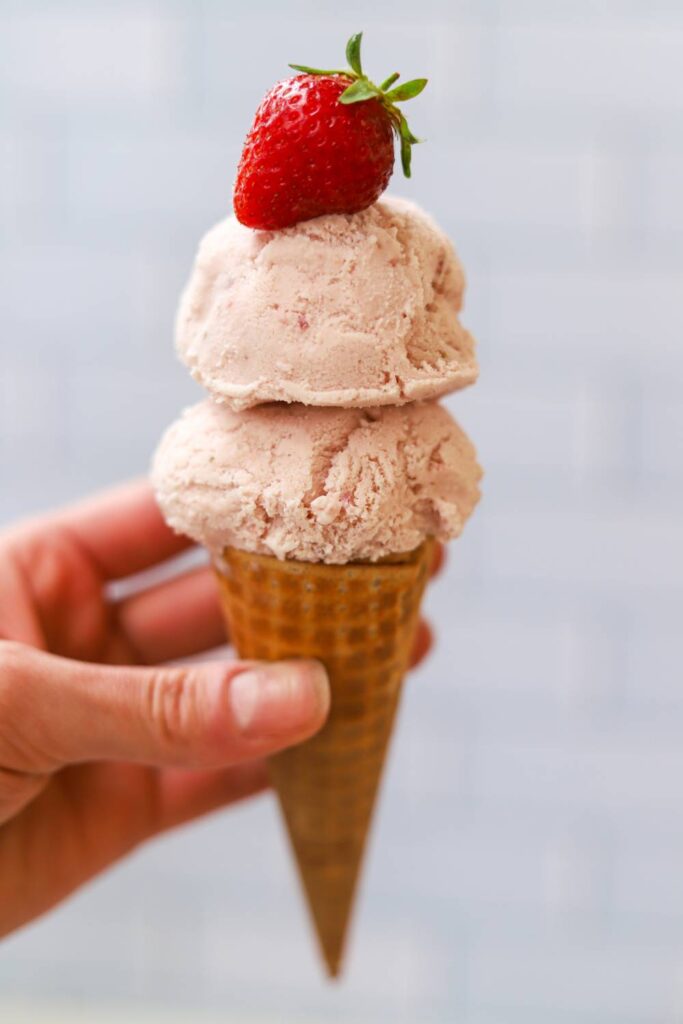 Strawberry ice cream in a waffle cone