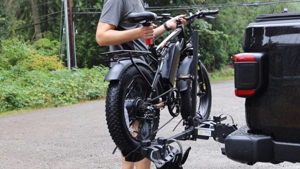 Man loading the Qlife Racer electric bike onto a bike rack