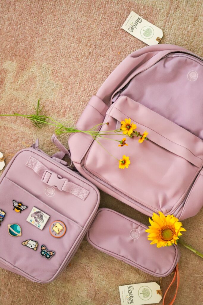 purple Parker Kids backpack, lunchbox, and pencil case with flowers