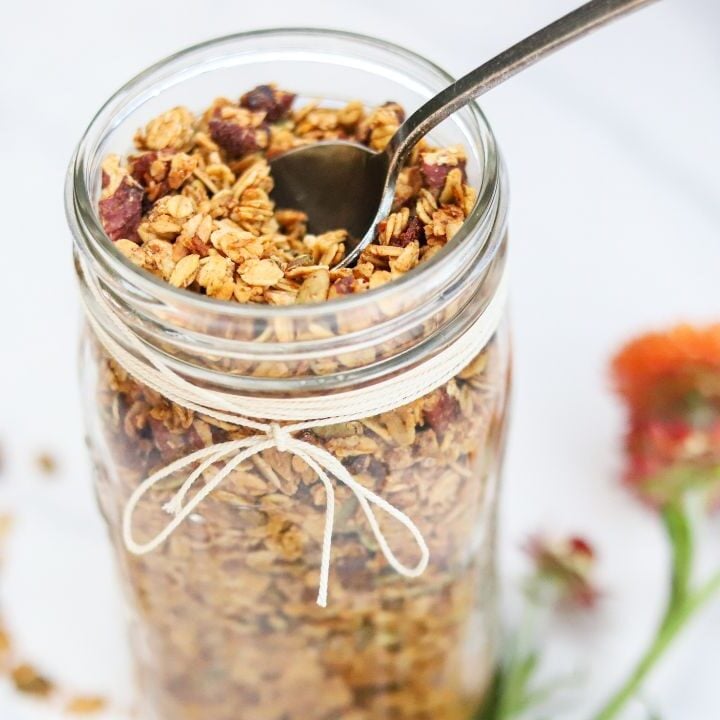 Jar of pumpkin spice granola with a spoon