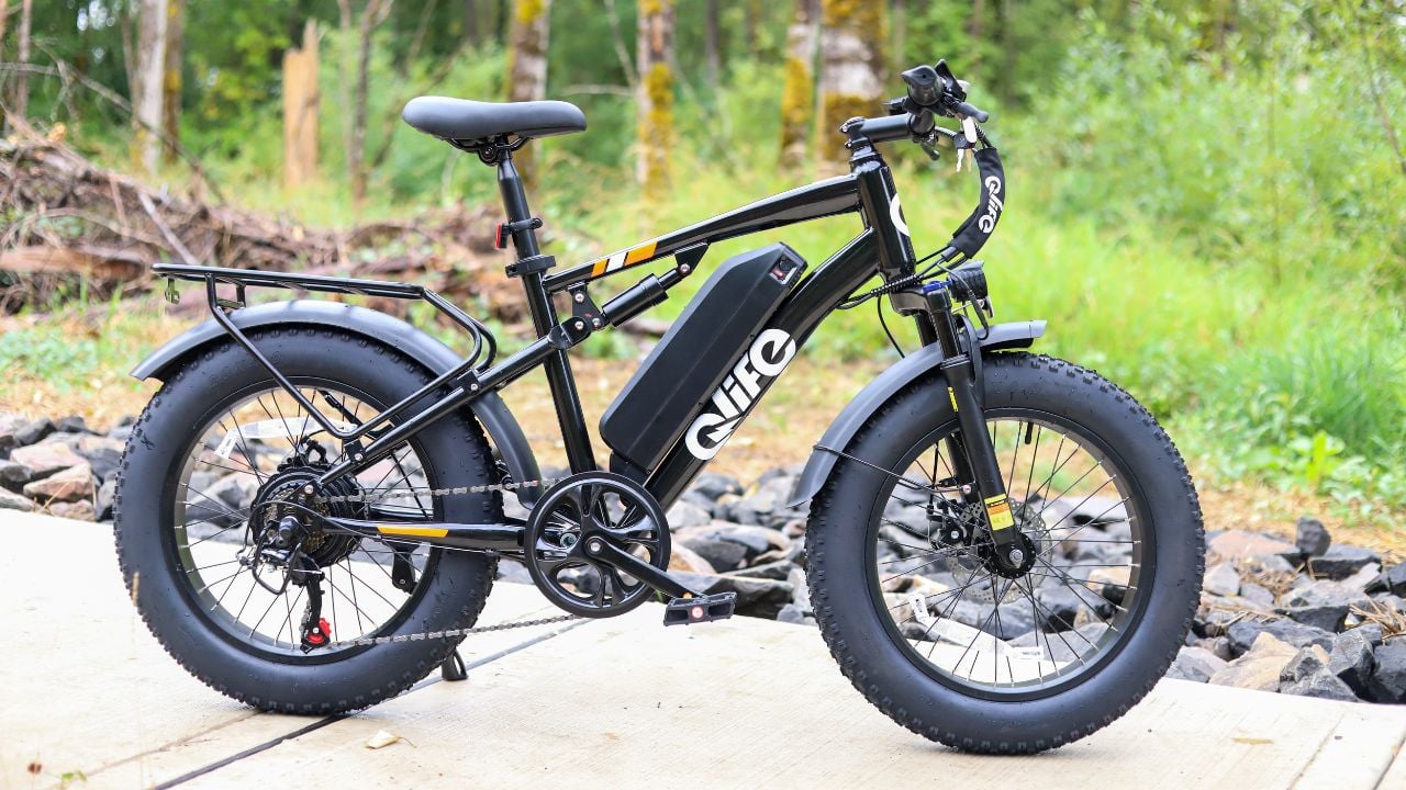Qlife Racer fat tire electric bike on a wooded trail