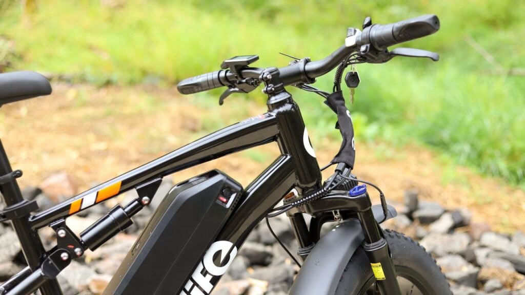 Close-up of the Qlife Racer electric bike handlebars and battery