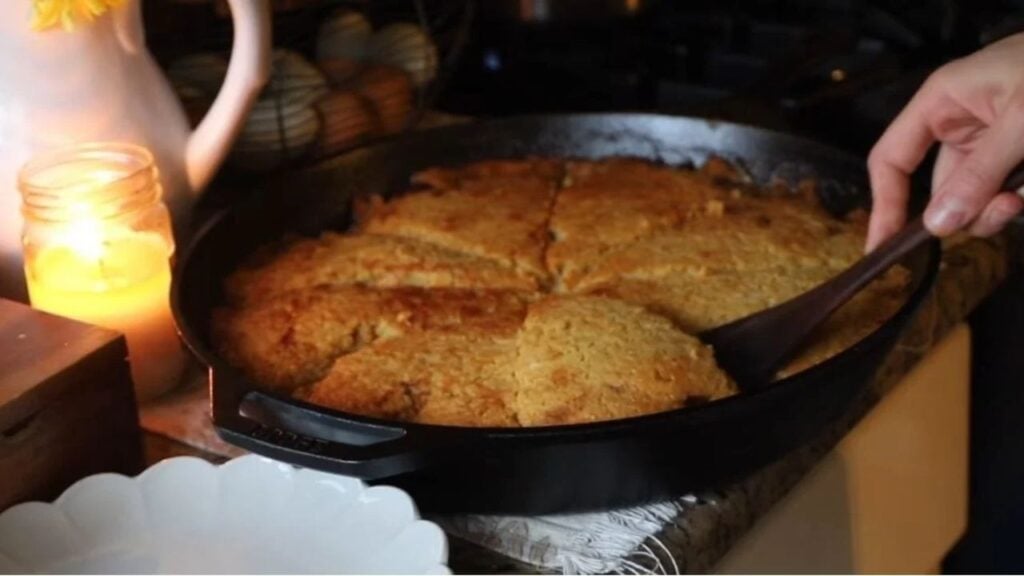 Cast iron skillet filled with golden homemade cornbread.