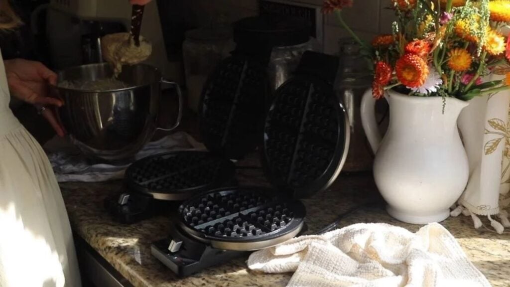 Open waffle makers ready for making homemade waffles for family breakfast.