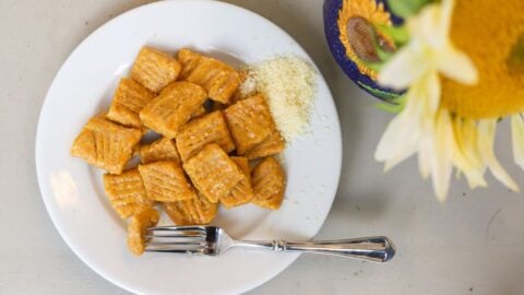 Cooked pumpkin gnocchi served with grated Parmesan cheese.
