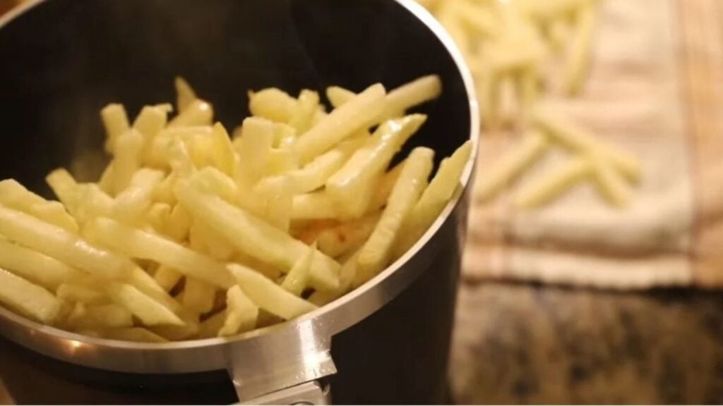 Fry Daddy deep fryer filled with golden french fries.